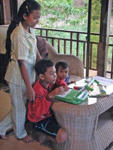 Children try out OLPC laptops in village in Kien Svay, Cambodia