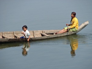 Children learn to use boats on the Mekong at an early age.