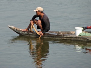 After he casts his net, the fisherman waits for the fish to arrive.
